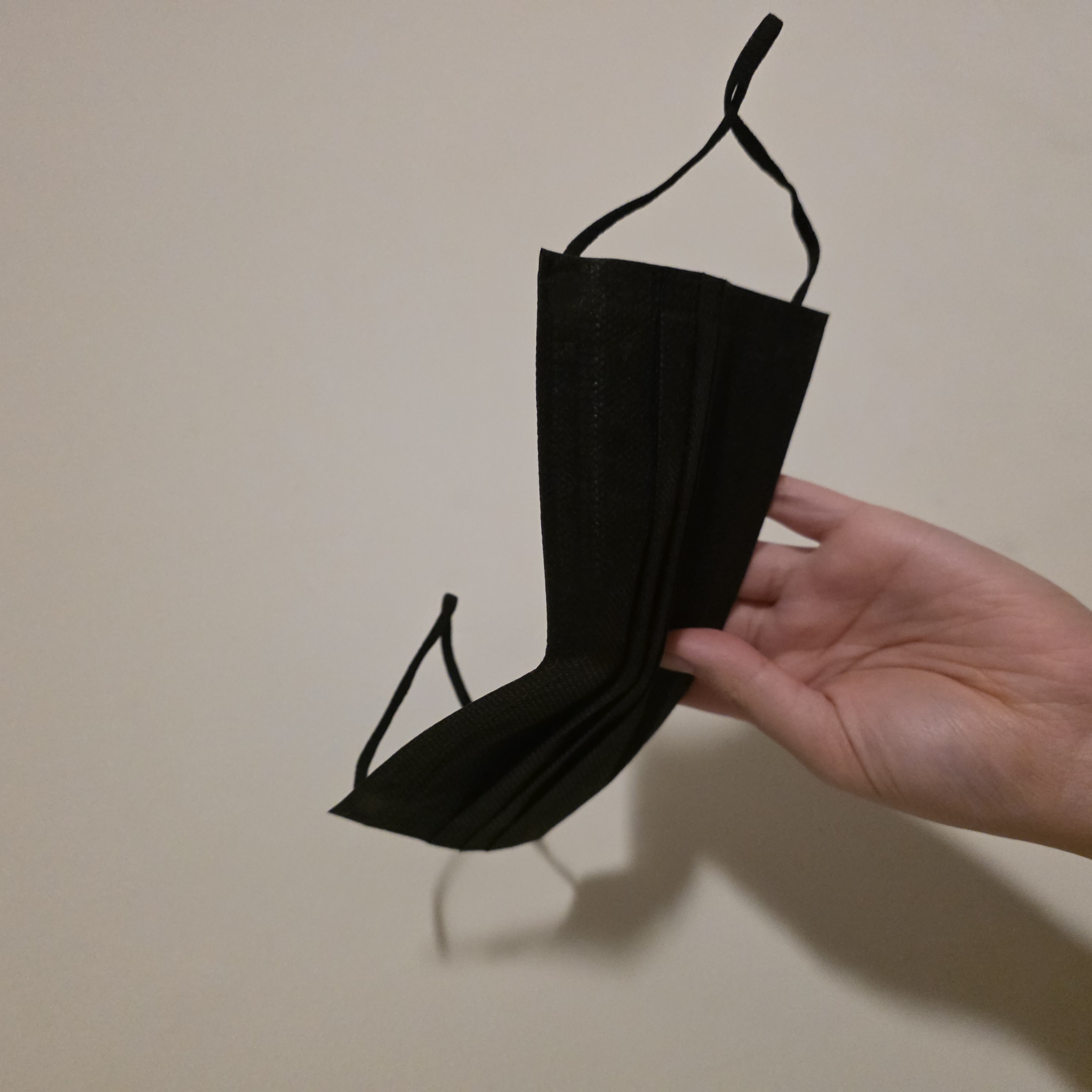 Adjusting a Face Mask is  wearable interaction because it's pinching the metal nose-bridge to mold the wear