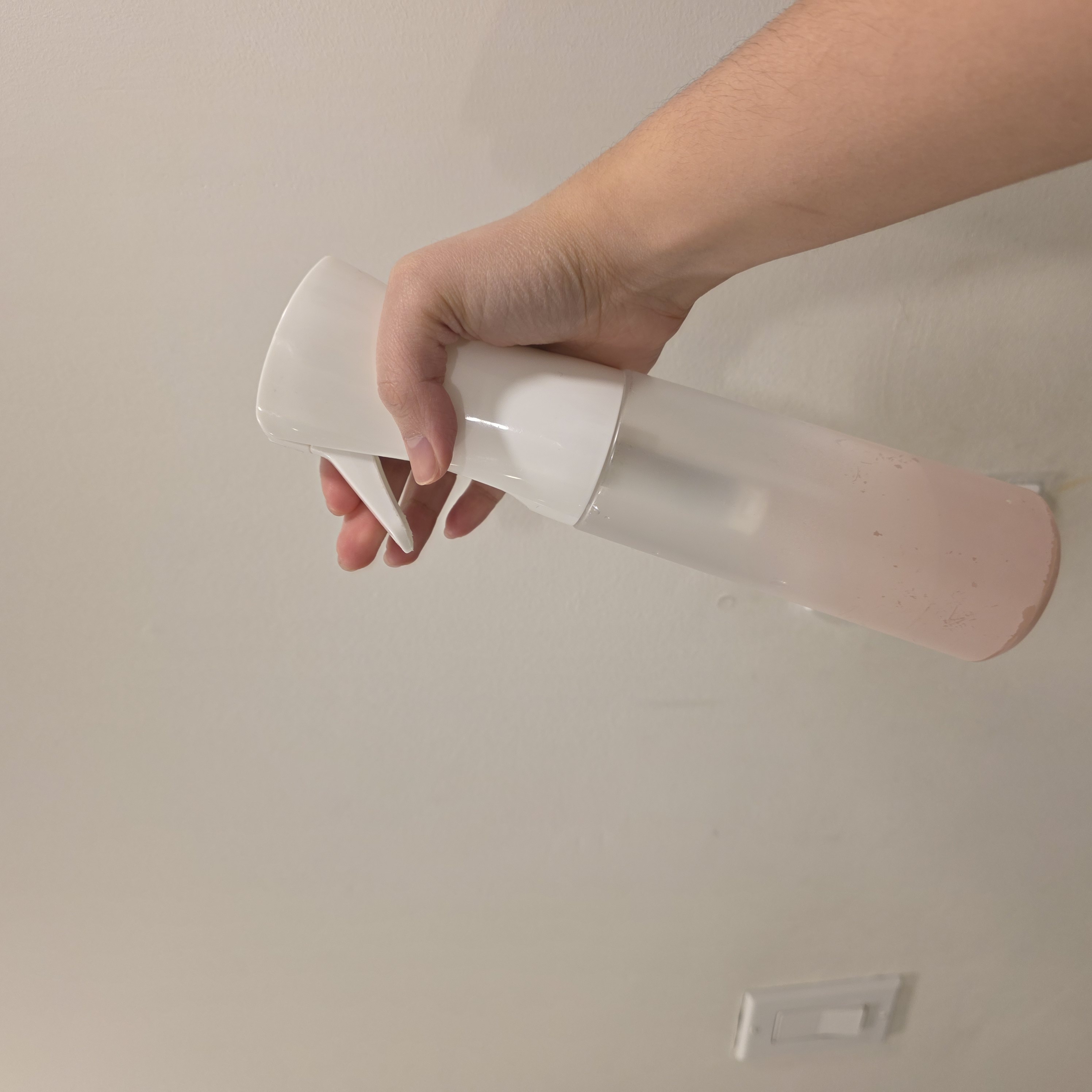 A spray bottle is primarily an object-based interaction where you use your index and middle fingers to perform a rhythmic 